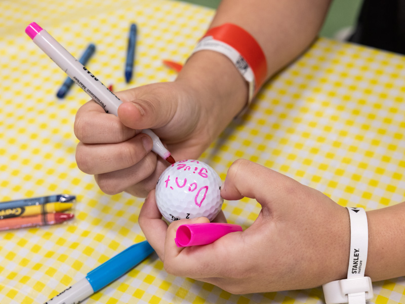 Children's of Mississippi patients wrote messages on golf balls. Makayla Jones of Moss Point writes "Don't give up."