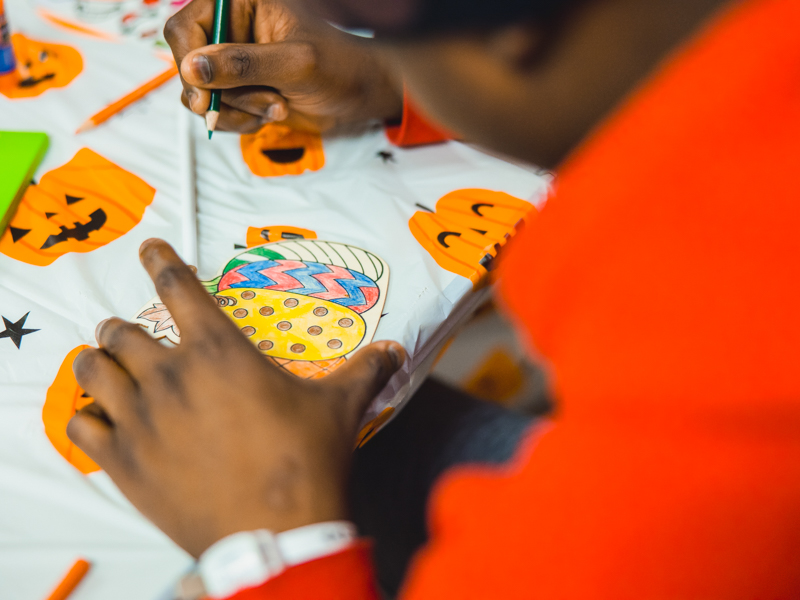 Children's of Mississippi patient Kelton Leavy creates Halloween art during REACH Night, a project of the Junior League of Jackson.
