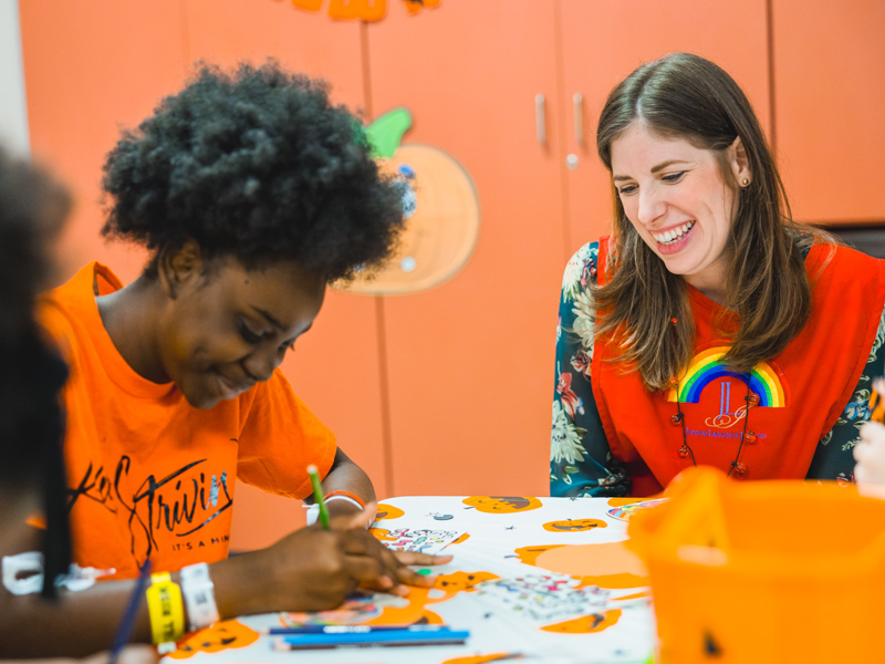 Children's of Mississippi patient Meshunda Nobles enjoys a Halloween art project with Junior League of Jackson volunteer Sarah Denney.