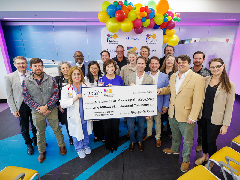 Children's of Mississippi leaders gathered with barbecue team members and Hogs for the Cause organizers to celebrate the New Orleans-based barbecue and music festival's $1.5 million gift to the state's only children's hospital.
