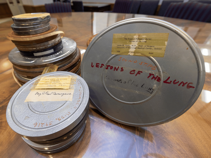 Among the film cans are these two, labeled, left, "popliteal aneurysms" and, right, "Lesions of the Lung," from the Dr. James D. Hardy Collection.