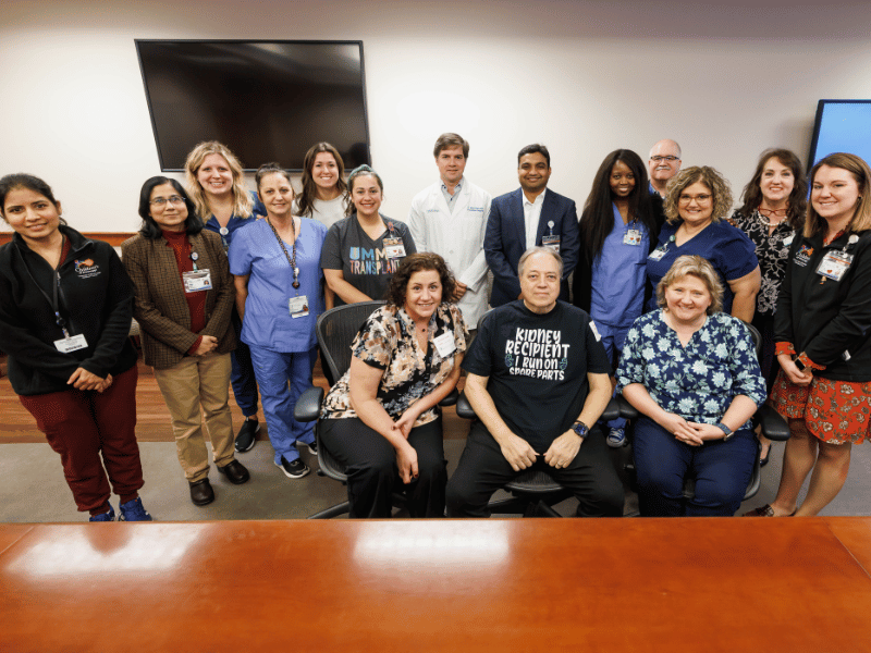 Rayborn, kidney recipient Jeff, center, and Tina Highs are surrounded by dedicated transplant staff, including administrators, surgeons, nephrologists, nurses, coordinators and navigators.