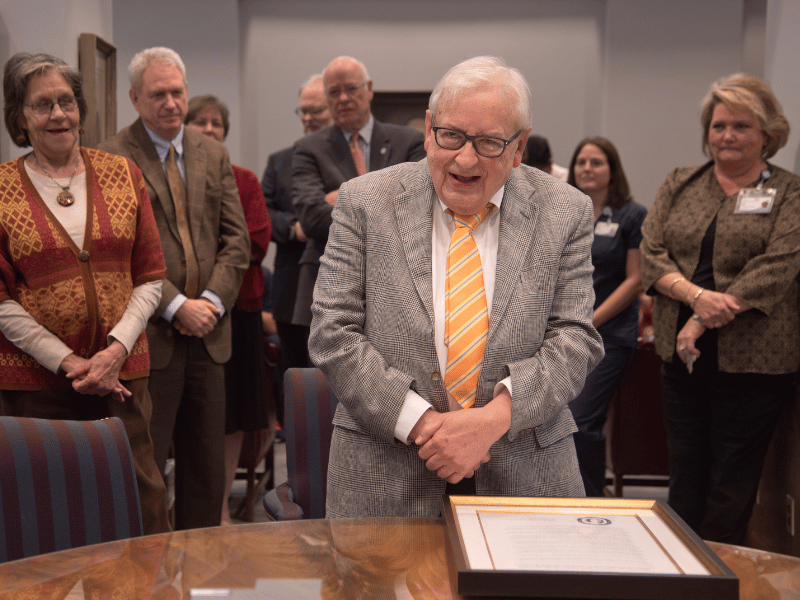 Dr. Julius Cruse, foreground, pictured in this file photo at a celebration of his retirement, established UMMC’s Division of Immunopathology and Transplant Immunology and pathology graduate studies program, which he served as director.
