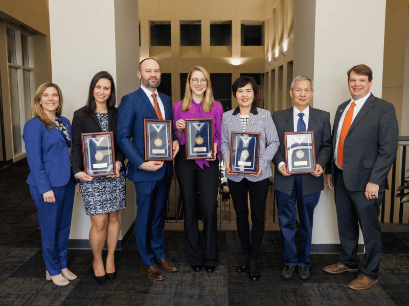 Bronze awards recipients, from second left to right, Dr. Lorena Amaral, Dr. Matthew Kutcher, Dr. Lais Berro, Dr. Heng Zeng and Dr. Xinchun Zhou. Not pictured are Dr. April Carson and Dr. Hao Mei.