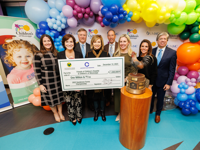 Applauding the $1 million donation to Friends of Children's Hospital from Century Club Charities are, from left, Pic Billingsley, senior vice president and general manager of retail sales for Wayne-Sanderson Farms; Dr. Mary Taylor, Suzan B. Thames Chair and professor of pediatrics; Phillip Carpenter, Century Club Charities president; Dr. LouAnn Woodward, vice chancellor for health affairs and dean of the School of Medicine; Kristin Allen, Friends of Children's Hospital board chair; Steve Jent, Sanderson Farms Championship executive director; and Hilary Burroughs, director of marketing for Wayne-Sanderson Farms.