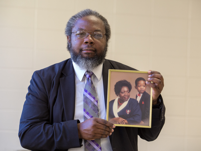 In this 2018 file photo, Smith holds a portrait of his sister, Dorothy Ann Johnson, and her son, Shannon; the portrait was made years before she died of colon cancer.
