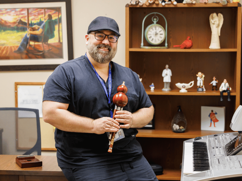 Dr. Sam Dickinson keeps musical instruments from a kalimba to a keyboard on hand at the School of Nursing.