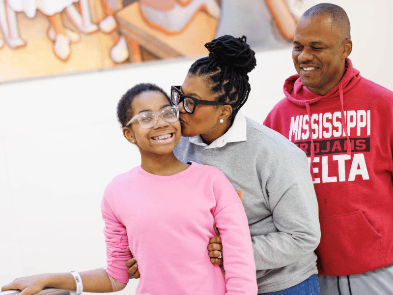 Kennedi Jackson gets a kiss from mom Kashanta Jackson as dad Tyrone Jackson looks on.