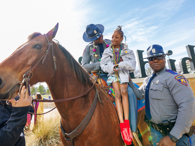 Ashanti Blockmon gets to sit atop a horse with a little help from the Mississippi Highway Patrol.