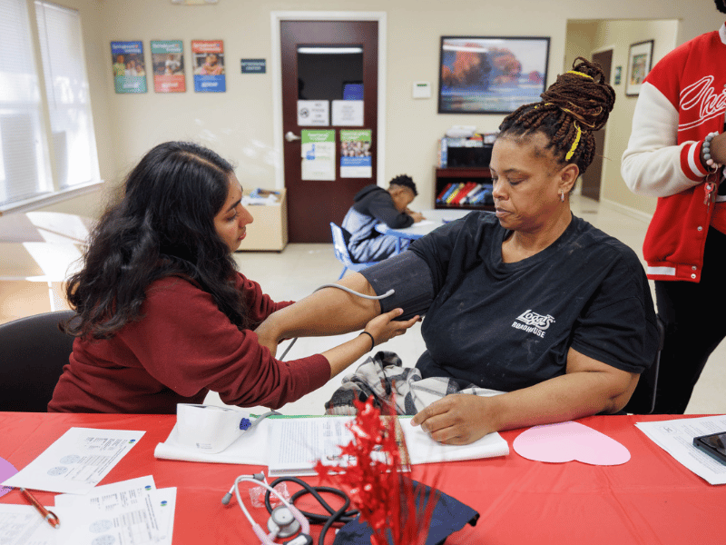 On the day before Valentine's Day, Elaine Jones, right, of Jackson gets her blood pressure checked by Student Health Coalition member Alka Ghadiyaram at Northwood Village Apartments during one of the coalition's many screening events.