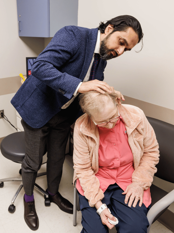 Chohan examines patient Georgia Pritchard's incision site to ensure it has healed.