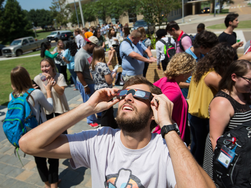 In this file photo, students and others gather on the UMMC campus to view the solar eclipse of Aug. 21, 2017. UMMC ophthalmologists advise observers to take in today's eclipse indirectly or with handheld viewers and solar eclipse glasses from reputable vendors.