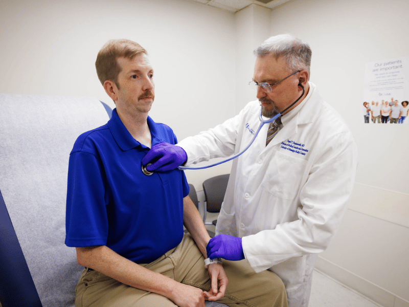 Dr. Pawel Pomianowski, medical director of the newly-established Division of Genetics and Genomics, listens to Brian McDade's heart.