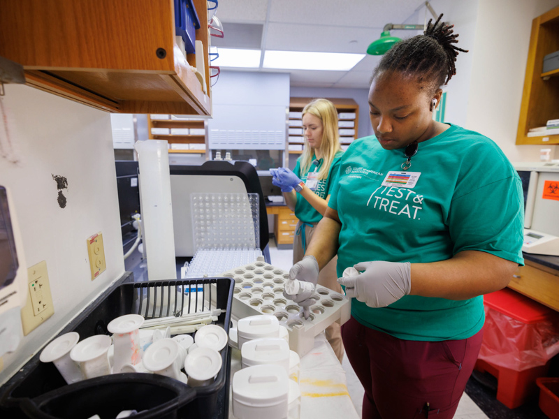 Cytotechnician Camrell Williams processes cervical cytology specimens in the Cytology Laboratory at UMMC.