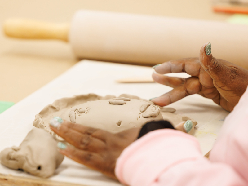 During the March session of Art in Mind, Trese Evans transforms her lump of clay into a face: “I kind of thought of myself when I was making it,” she says.