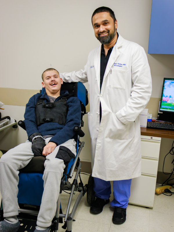 Dr. Omar Chohan, associate professor of neurosurgery, poses with patient James Canfield of Moss Point during a follow up appointment.