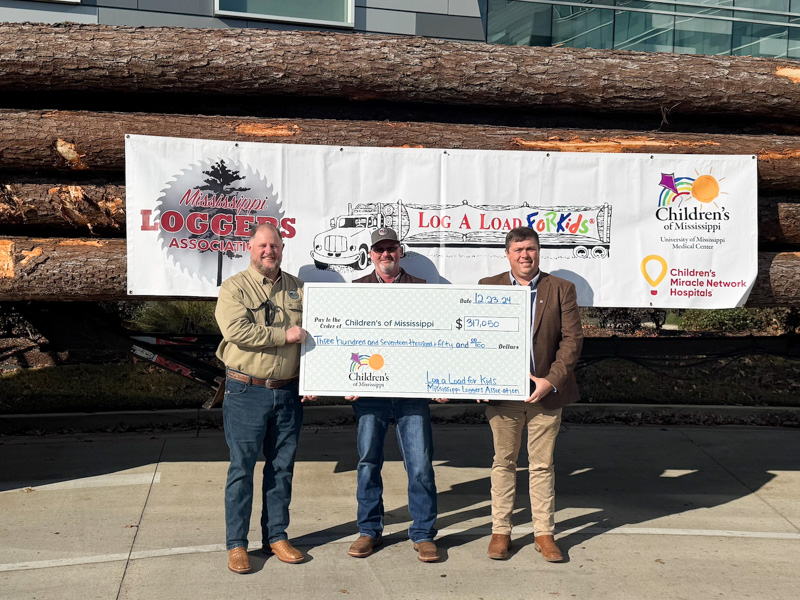 Presenting 2024's Log-A-Load For Kids donation are, from left, David Livingston, Mississippi Loggers Association executive director; Roy Holder, Enviva commodity manager and an auctioneer; and logger Drew Massey.