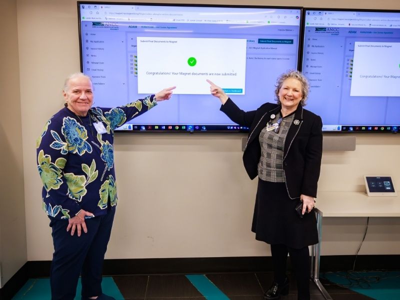 Fran Malenzi, Nursing Magnet Program director, and Ellen Hansen, chief nursing and clinical services officer for Children's of Mississippi, point to proof of the Magnet application's submission.