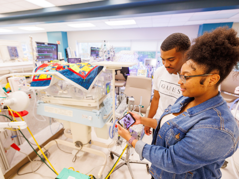 PaDasia and Desmone Matthews show how AngelEye works beside their son Deuce's Isolette at Wiser Hospital for Women and Infants.