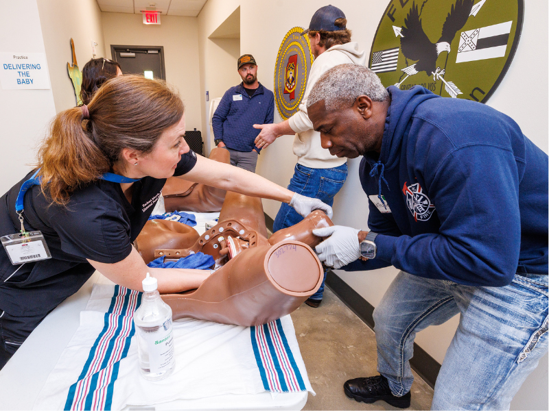Dr. Rachael Morris coaches Lieutenant Nathaniel Nichols of the Vicksburg Fire Department through hands-on training.