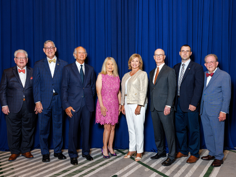 Dr. LouAnn Woodward, vice chancellor for health affairs and dean of the School of Medicine, fourth from right, congratulates the Medical Alumni Awards honorees, from left: Dr. D. Stanley Hartness, Dr. Timothy Folse, Dr. Anthony Petro, Dr. Sharon Douglas, (Woodward), Dr. Charles O'Mara, Dr. James Dustin Gentry and Dr. G. Rodney Meeks.