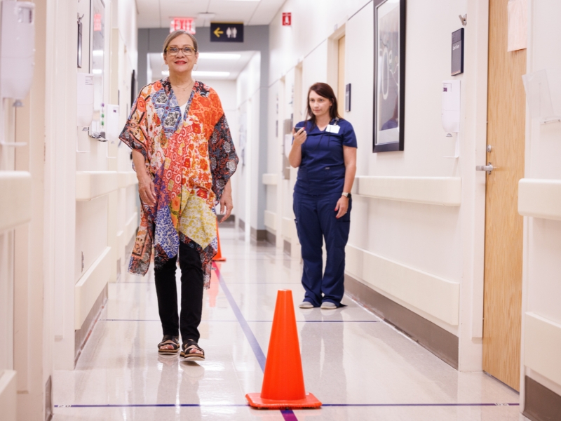 Kimberly Burt, of Jackson, walks the hallway of the clinical lab at The MIND Center as part of her participation in a study that aims to identify some of the root causes of dementia.