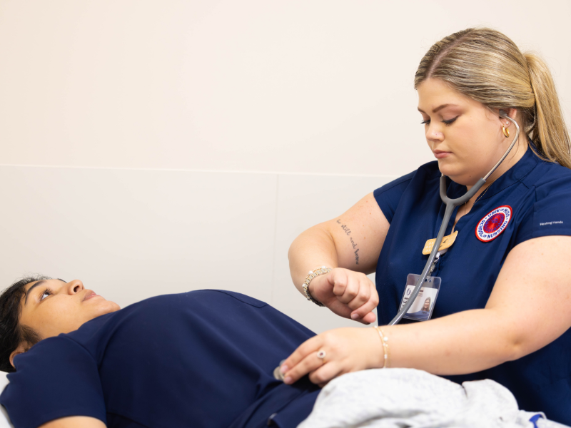 Traditional BSN students Valerie Camargo, left, and Audrey Ezell practice clinical skills.