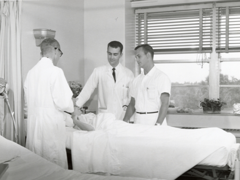Dr. Michael Baumann, left, takes Dr. Charlie Brunson, a senior resident, and Trey O'Neal, a fourth-year medical student, on rounds in UMMC's medical ICU. (Archival photo)