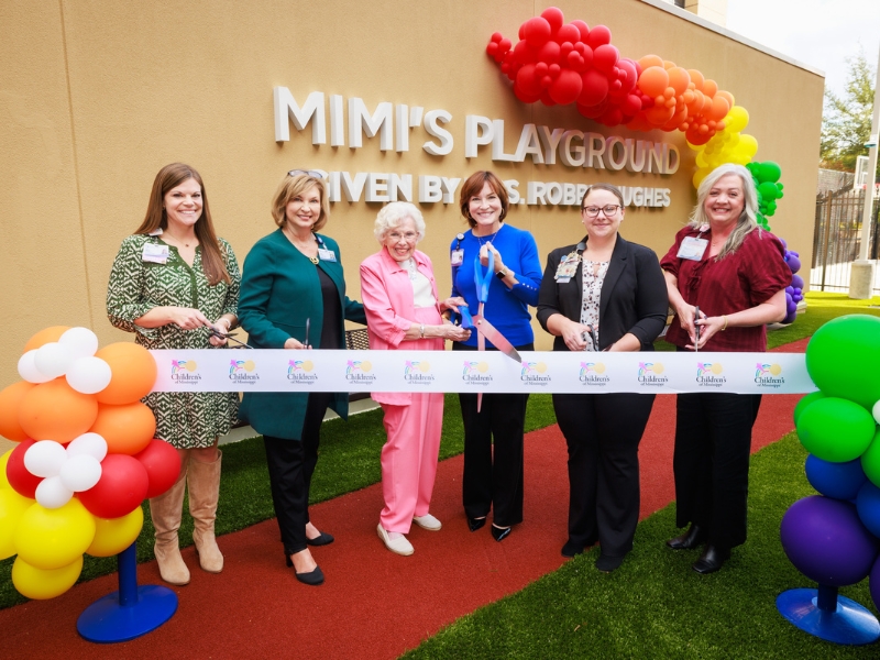 Cutting the ribbon on Mimi's Playground are, from left, Cara Williams, child life manager; Dr. LouAnn Woodward, vice chancellor for health affairs; philanthropist Robbie Hughes; Dr. Mary Taylor, Suzan B. Thames Chair of Pediatrics and incoming CEO of Children's of Mississippi; Dr. Nikki Cowan, director of nursing for Children's of Mississippi's medical-surgical and behavioral health units; and Tara Husband, director of Children’s Rehabilitative Services.