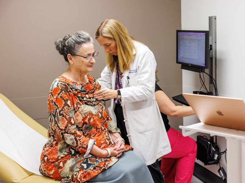 Dr. Carter Milner checks patient Diann Jackson during a clinic visit at the UMMC Cancer Center and Research Institute.