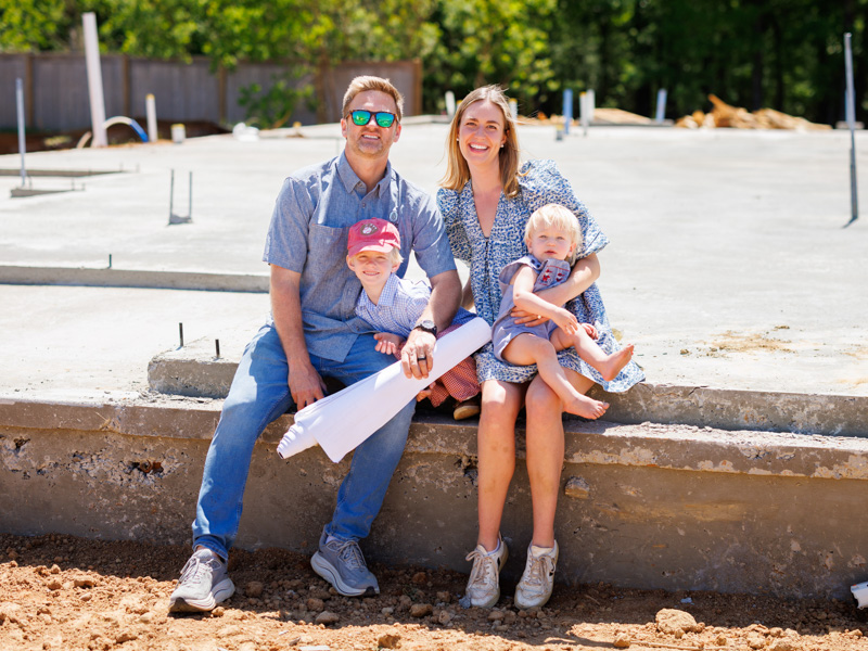 John and Mary Kathryn Decker with their children, John Walker, 5, and Archer, 16 months, at The Village of Madison where John has built several houses and has more underway.