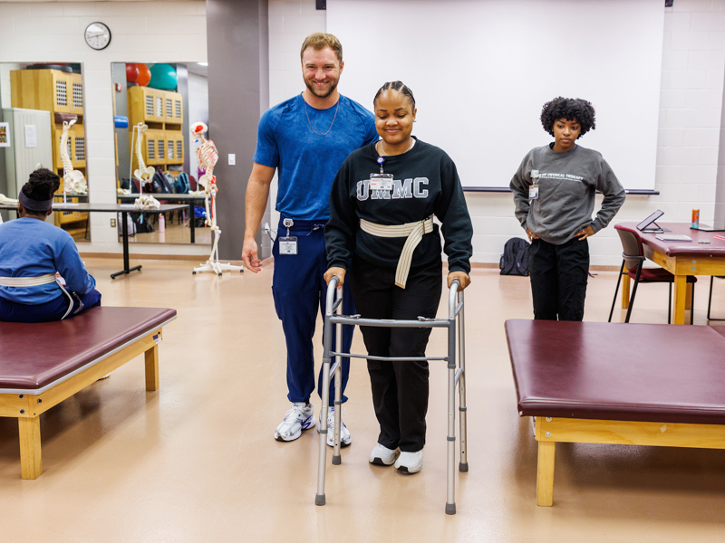 Camia White, a student in the Doctor of Physical Therapy program, acts as a mock patient during Acute Care in Physical Therapy II class in the PT lab with fellow PT student Drew Horton.