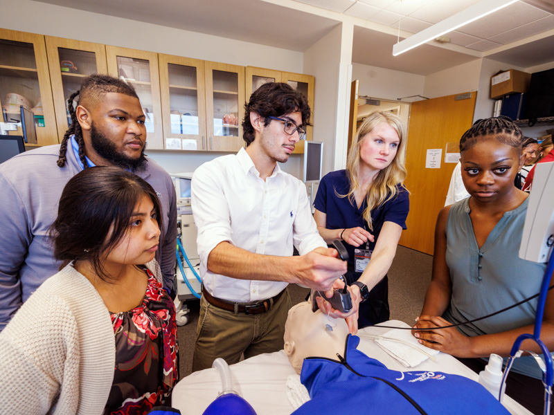Learning incubating techniques, Victor Diaz-Ornelas, a first-year student in the P.R.O.M.I.S.E. Program, receives hands-on training from Dr. Jessie Harvey, associate professor in the School of Medicine’s Pulmonary Division, alongside three other program participants, Luz Luna, Bryant Lewis and Madison Howard during an early clinical learning experience.