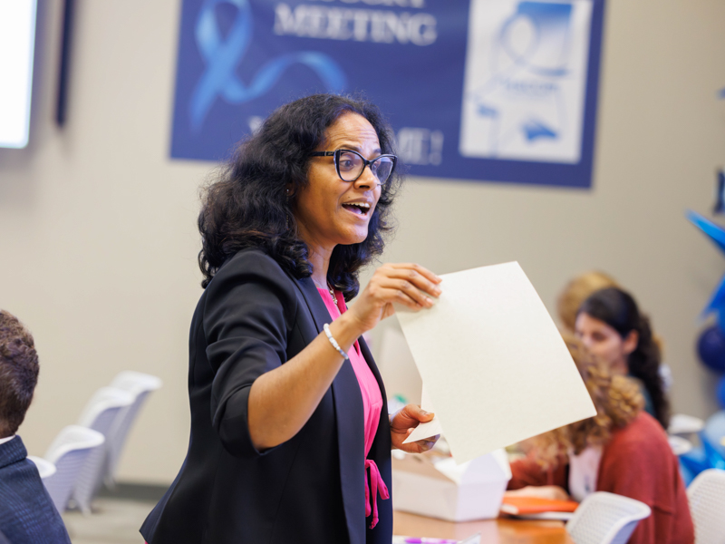Dr. Manju George, assistant professor of population health science, encourages roundtable members to sign pledges noting how they will work to increase colorectal cancer screenings by 2030.