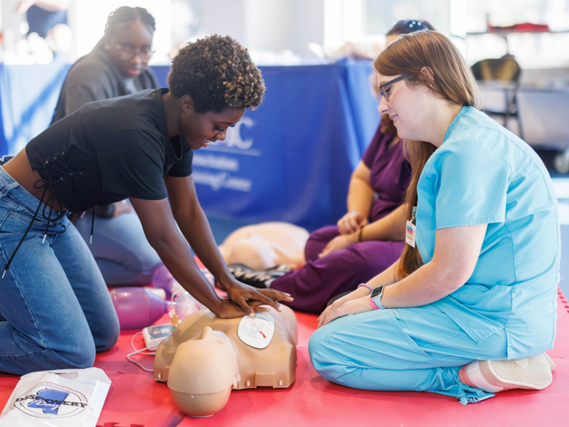 Peyton Loftin, a senior at Mendenhall High School, performs resuscitation training with Kristina Readman, life support training center educator, during Discovery Day.