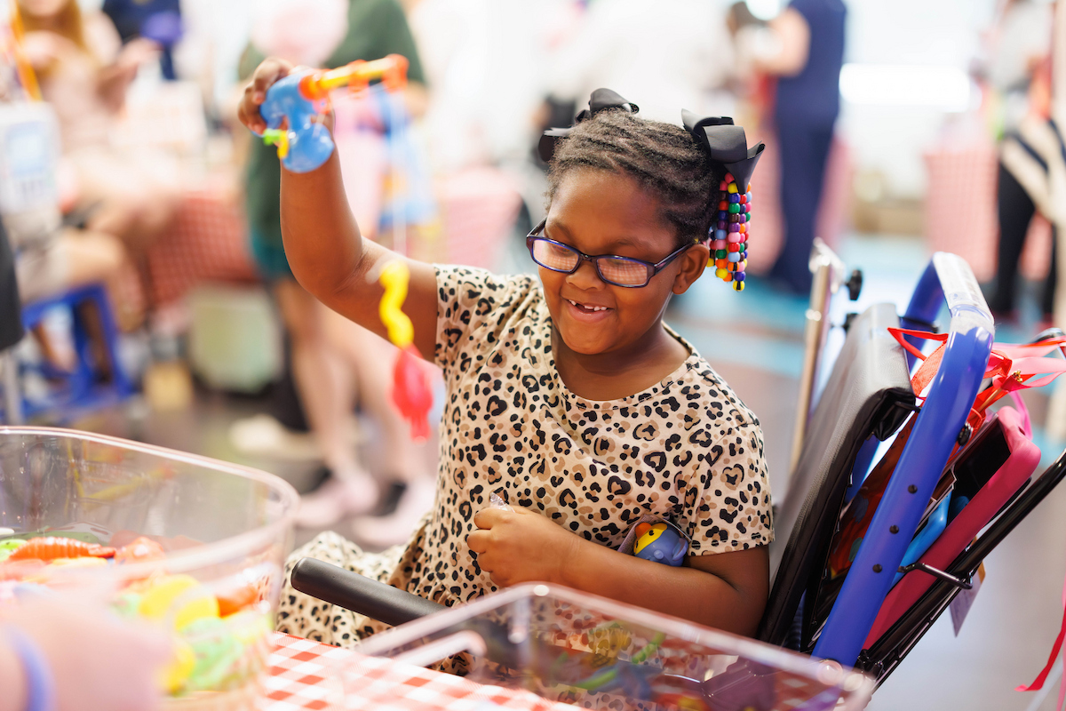 Bella Boyd, 6, of Jackson catches a fish while playing fair game at Fair with Friends.