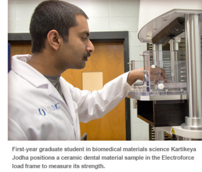 First-year graduate student in biomed ical materials science Kartikeya Jodha positions a ceramic dental material sample in the Electroforce load frame to measure its strength.