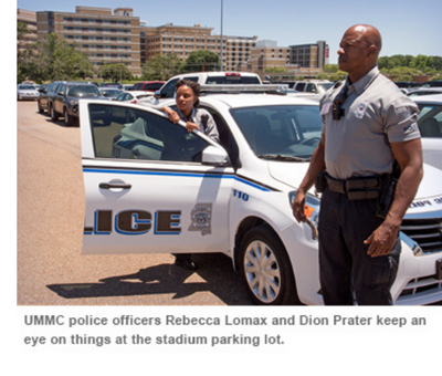 UMMC police officers Rebecca Lomax and Dion Prater keep an eye on things at the stadium parking lot.