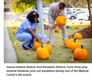 Ivanna Adams-Nelson and Benjamin Nelson, both third-year medical students, pick out pumpkins during one of the Medical Center's fall events.