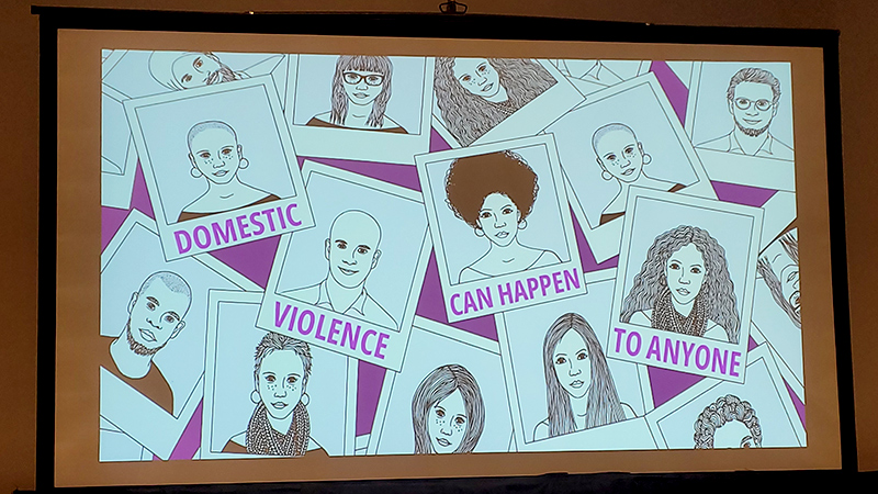 Domestic violence awareness slide featuring illustrated portraits of diverse individuals with the message: “Domestic Violence Can Happen to Anyone,” displayed on a presentation screen.