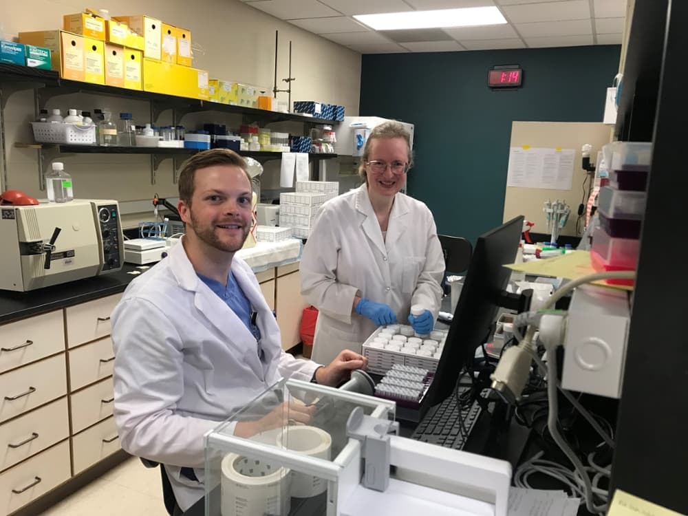 two researchers in the lad with beakers