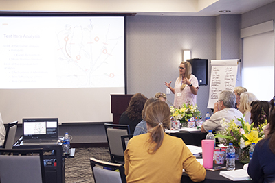 Dr. Katie Hall lecturing on ways to prepare to take the Certified Nurse Educator Exam to Bower faculty scholars.