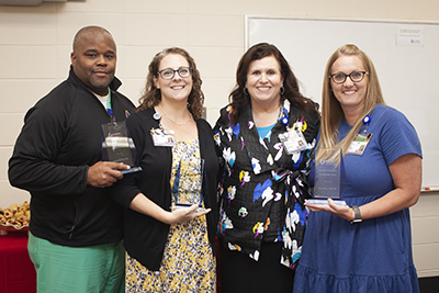 Dr. Derek Holt, Dr. Jennifer Hargett, and Dr. Katie Hall receiving their SON Excellence Awards from Dean Julie Sanford.