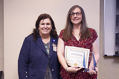 Tara Rushing receiving her SON Excellence Award from Dean Julie Sanford.