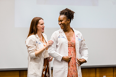 Photo of LaDaryl Watkins receiving her lab coat.