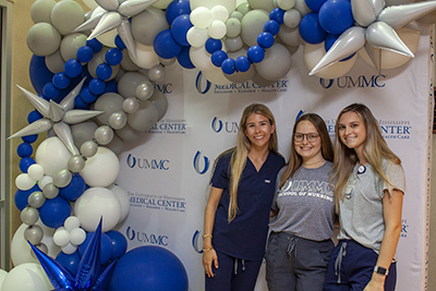 Students at a photo booth at a welcome back to school breakfast bash.