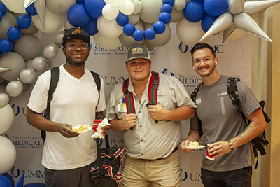 Students at a photo booth at a welcome back to school breakfast bash.