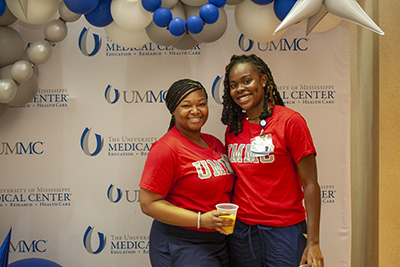 Students at a photo booth at a welcome back to school breakfast bash.