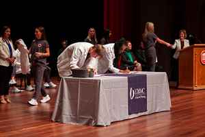 nursing students signing their names to the student honor code