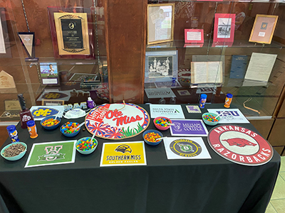 popcorn topping table set up with various college football logos